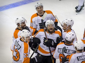 Philadelphia Flyers’ Ivan Provorov, Matt Niskanen, Oskar Lindblom, Tyler Pitlick, Nicolas Aube-Kubel and defenceman Robert Hagg celebrate Provrov’s game-winner against the New York Islanders in the second overtime period of Game 6 on Thursday night in Toronto.