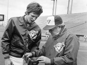 Toronto Blue Jays manager Bobby Mattick, right, looks over Danny Ainge's glove in Toronto in this May 15, 1980 file photo.