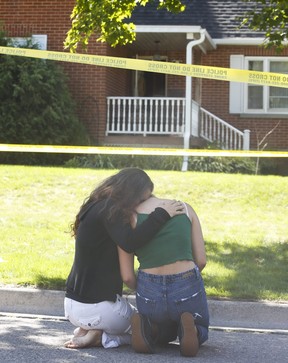 Mourners outside a home on Parklane Ave. in Oshawa where four people were murdered and a fifth injured in a shooting on Friday, September 4, 2020.
