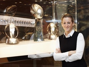 of Sam Rapoport poses at NFL headquarters in New York City in front of Lombardi Trophies.
