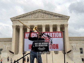 Sterling Anderson plays the saxophone outside the U.S. Supreme Court the day after President Donald Trump announced U.S. Court of Appeals Judge Amy Coney Barrett as his nominee to fill the Supreme Court seat left vacant by the death of Justice Ruth Bader Ginsburg, in Washington September 27, 2020.