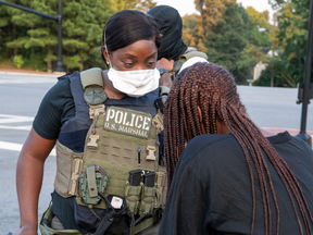 A US Marshal comforts a suspected sex trafficking victim. The Marshals recovered more than 300 missing children last year.