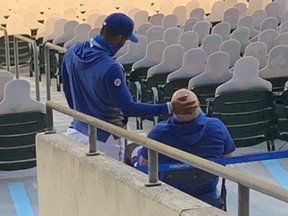 Injured Blue Jays players Teoscar Hernandez (left) and Rowdy Tellez monitor the action of their team’s 7-2 loss to the New York Yankees on Sept. 9, 2020, from the stands at Sahlen Field in Buffalo.