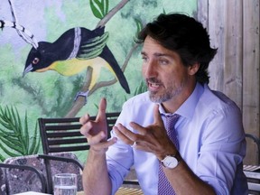 Prime Minister Justin Trudeau meets with local business owners to discuss the impacts of COVID-19 in a bistro in Montreal, on Monday, Aug. 31, 2020.