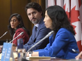 Prime Minister Justin Trudeau and Minister of Public Services and Procurement Anita Anand listen to Chief Public Health Officer of Canada Dr. Theresa Tam during a news conference on the COVID-19 pandemic on Parliament Hill in Ottawa, on Friday, Sept. 25, 2020.