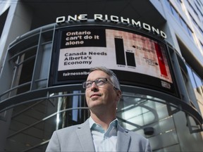 Bill Bewick, Executive Director, Fairness Alberta poses by an electronic billboard promoting the importance the Alberta's economy to Ontario, at the corner of Yonge and Richmond Sts in downtown Toronto, Ont. on Monday September 21, 2020. Ernest Doroszuk/Toronto Sun/Postmedia