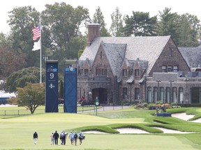 Golfers walk toward the ninth hole during a practice round for this week's U.S. Open Championship at Winged Foot Golf Club in Mamaroneck, N.Y.