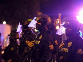 Police officers stand outside of First Unitarian Church of Louisville during a demonstration in downtown Louisville, Kentucky on September 24, 2020. -