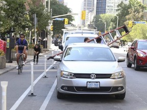 Cyclists are enjoying the newly created bike lanes along Bloor St. E., near Sherbourne St., but they had to navigate around couriers, cars and construction vehicles blocking the routes on Friday, Sept. 11, 2020.