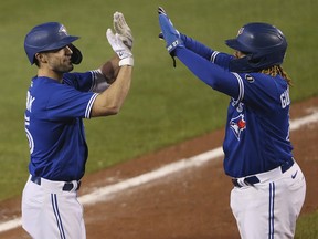Toronto Blue Jays outfielder Randal Grichuk,left, celebrates his three-run home run with Vladimir Guerrero Jr. during their  game against the Baltimore Orioles, Saturday, Sept. 26, 2020, in Buffalo, N.Y.