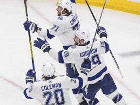 Tampa Bay Lightning’s Anthony Cirelli (back right) celebrates his series-clinching goal against the New York Islanders with teammates Barclay Goodrow (left) and Blake Coleman on Thursday night in Edmonton. The Bolts face the Stars in the Stanley Cup final.