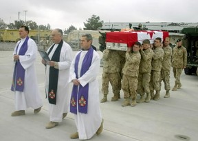 Three Canadian Forces Chaplains lead the pallbearer party for Canadian diplomat Glyn Berry as his remains are carried to a CC-130 Hercules Aircraft at Kandahar Airfield in Afghanistan on Jan. 17, 2006.