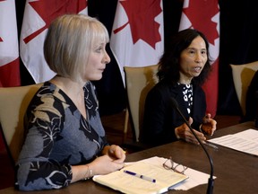 Minister of Health Patty Hajdu, left, listens as Chief Public Health Officer of Canada Dr. Theresa Tam participates in a press conference following the announcement by the Government of Ontario of the first presumptive confirmed case of a novel coronavirus in Canada, in Ottawa, on Sunday, Jan. 26, 2020.