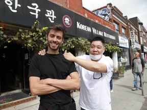 Jason Lee (R) owner of Korean Village Restaurant and his friend Andrew Oporto (L) stand outside the restaurant. Harris has be helping his friend working as a server for free on Thursday, Sept. 17, 2020.