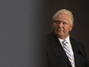 Ontario Premier Doug Ford stands at the lecturn during a joint press conference with Ontario Premier Doug Ford, at the Ontario-Quebec Summit in Toronto on Wednesday, September 9, 2020.