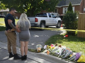 A memorial grows in front of the home where five family members were shot and killed on Saturday, Sept. 5, 2020.