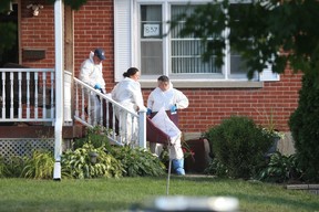 Durham Regional Police remove a body from a house on Parklane Ave. in Oshawa where five people were found shot to death on Friday, Sept. 4, 2020.