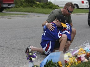 A memorial grows in front of the home where five family members were shot and killed on Saturday, Sept. 5, 2020.