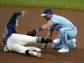 Blue Jays second baseman Joe Panik tags out Tampa Bay Rays’ Michael Brosseau at second base after Brosseau was caught trying to stretch a single into a double during the first inning in Game 2 of their opening-round series in St. Petersburg, Fla., 
on Wednesday night. Panik said playing through the pandemic was a “chaotic” experience for the young Jays.