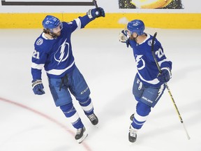 Lightning’s Brayden Point (left)) and Kevin Shattenkirk celebrate a goal during Game 1 on Monday against the Islanders. Point finished with five points in the game.