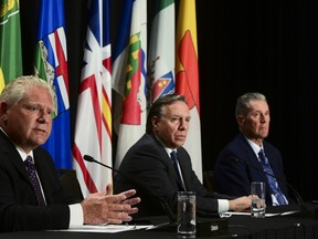 Ontario Premier Doug Ford, left, speaks as Quebec Premier Francois Legault, centre, and Manitoba Premier Brian Pallister look on during a press conference in Ottawa on Friday, Sept. 18, 2020.