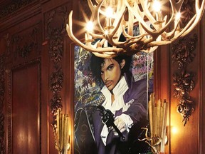Thierry Guetta and his portrait of Prince, on view at the recently awarded BlueBlood steakhouse in Casa Loma, Toronto.