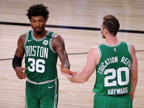Marcus Smart, left, and Gordon Hayward, right, of the Celtics react during the fourth quarter against the Heat in Game 3 of the Eastern Conference Finals during the 2020 NBA Playoffs at AdventHealth Arena at the ESPN Wide World Of Sports Complex in Lake Buena Vista, Fla., Saturday, Sept. 19, 2020.