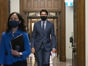 Prime Minister Justin Trudeau arrives with Canada's Chief Public Health Officer Dr. Theresa Tam, left, for a news conference on the COVID-19 pandemic on Parliament Hill in Ottawa, on Friday, Sept. 25, 2020.