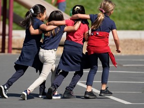 Students run and play on the playground at a school in in Provo, Utah on Sept. 10, 2020.