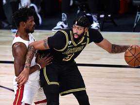 L.A. Lakers' Anthony Davis is defended by Miami Heat forward Jimmy Butler.