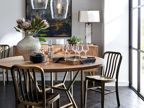 A modern dining space, lit from above, with taupe walls and a wooden table, sets a relaxing, rustic tone.
Photo:  Crate and Barrel