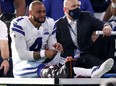 Dak Prescott of the Dallas Cowboys is carted off the field after sustaining a leg injury against the New York Giants during the third quarter at AT&T Stadium on October 11, 2020 in Arlington, Texas.