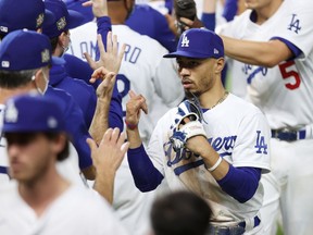 Mookie Betts of the Los Angeles Dodgers celebrates with his teammates after their 8-3 victory against the Tampa Bay Rays in Game 1 of the 2020 World Series at Globe Life Field on Oct. 20, 2020 in Arlington, Texas.