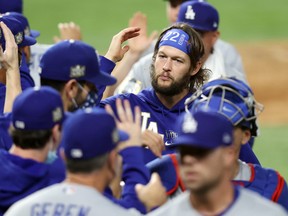 Clayton Kershaw #22 of the Los Angeles Dodgers celebrates with his teammates following their 4-2 victory against the Tampa Bay Rays in Game Five of the 2020 MLB World Series at Globe Life Field on October 25, 2020 in Arlington, Texas.