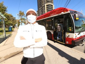 Nurse Christian Don Evangelista is pictured in front of a TTC bus on Oct. 13, 2020. (Jack Boland, Toronto Sun)