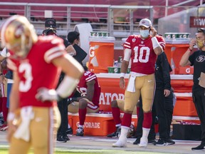 San Francisco 49ers quarterback Jimmy Garoppolo wears a mask on the sideline earlier this season.