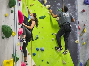 Emily Maini (left) and Tanish Nagpal scale walls at Aspire Climbing rock climbing gym in Milton  on Oct. 25, 2020. Business owners fear the province will shut down operations like this on Monday in a bid to curb the rising number of COVID-19 cases.
