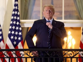 U.S. President Donald Trump gestures on the Truman Balcony after returning to the White House from Walter Reed National Military Medical Center on Oct. 5, 2020 in Washington, DC. .