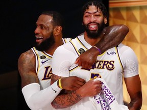 Lakers forward LeBron James (23) and forward Anthony Davis (3) celebrate during the fourth quarter in game six of the 2020 NBA Finals at AdventHealth Arena. The Los Angeles Lakers won 106-93 to win the series. Credit: Kim Klement-USA TODAY Sports ORG XMIT: IMAGN-430889