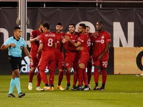 Oct 14, 2020; Hartford, CT, USA; Toronto FC midfielder Alejandro Pozuelo (10) is congratulated after scoring on a penalty shot against the New York Red Bulls in the first half at Pratt & Whitney Stadium at Rentschler Field. Mandatory Credit: David Butler II-USA TODAY Sports ORG XMIT: IMAGN-430773