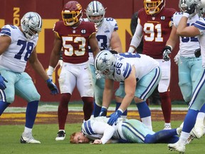 Dallas Cowboys quarterback Andy Dalton lies on the field after being hit by Washington linebacker Jon Bostic (53) and knocked out of the game in the third quarter at FedExField last Sunday.