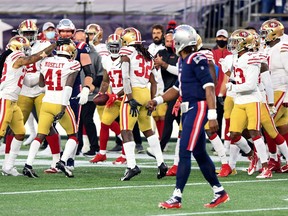 San Francisco 49ers cornerback Emmanuel Moseley (41) celebrates with teammates after a pick-six against New England Patriots quarterback Cam Newton (1) on Sunday at Gillette Stadium.