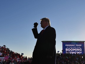 U.S. President Donald Trump gestures to supporters after speaking at a campaign rally at Green Bay Austin Straubel International Airport in Green Bay, Wis. on Oct. 30, 2020.