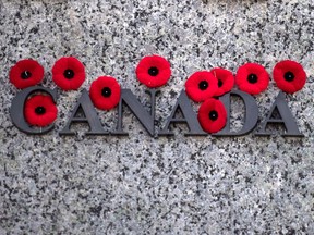 Poppies are seen on the National War Memorial after Remembrance Day ceremonies, in Ottawa on Sunday, Nov. 11, 2018.