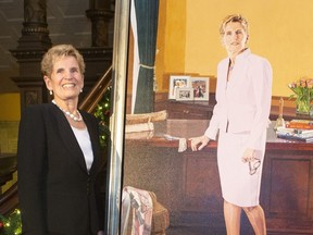 Former Ontario premier Kathleen Wynne stands beside her portrait, painted by Linda Dobbs, after its unveiling ceremony at the Ontario legislature, in Toronto, Nov. 9, 2019.