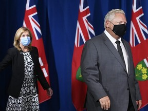 Ontario Premier Doug Ford, right, and Health Minister Christine Elliott arrive for a news conference at Queen's Park  in Toronto on Monday, September 28, 2020.