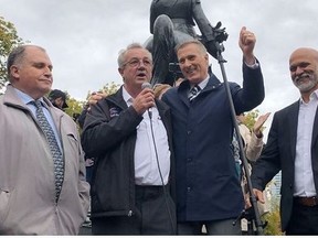 MPP Randy Hillier (centre,left) and People's Party of Canada Leader Maxime Bernier (next to him) addressed a crowd at the rally where a man was arrested.