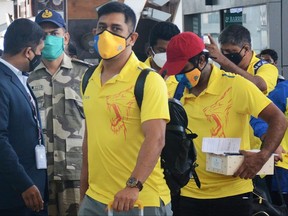 In this file photo taken on August 21, 2020, Chennai Super Kings captain Mahendra Singh Dhoni (C) arrives along with his teammates at the airport in Chennai to take a flight to Dubai for the upcoming Indian Premier League (IPL) cricket tournament.