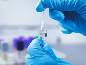 A lab technician processes a DNA sample