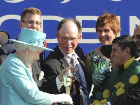 Her Majesty Queen Elizabeth presents the 2010 Queen's Plate to the connections of Big Red Mike, left to right, Mike Romeo, son of owner Dom Romeo, trainer Nick Gonzalez, Martha Gonzalez and jockey Eurico Da Silva.